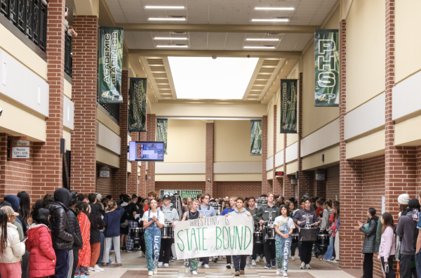 As students cheer, the Prosper wrestling team gets recognized before they head off to the state meet. The team competed over the weekend. Senior Jack Ringger took first runner up in the state meet. 